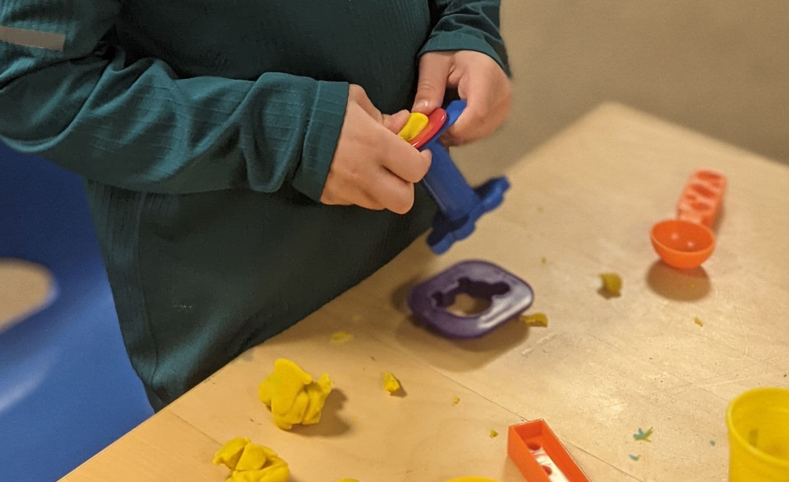 Small hands shaping Play-Doh